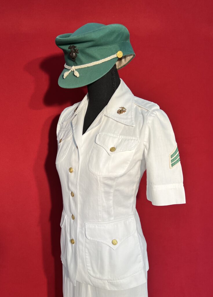 White marine uniform with green cap on red background