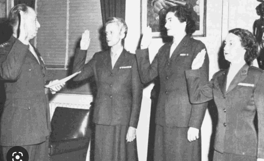black and white photo of female marines taking their oath